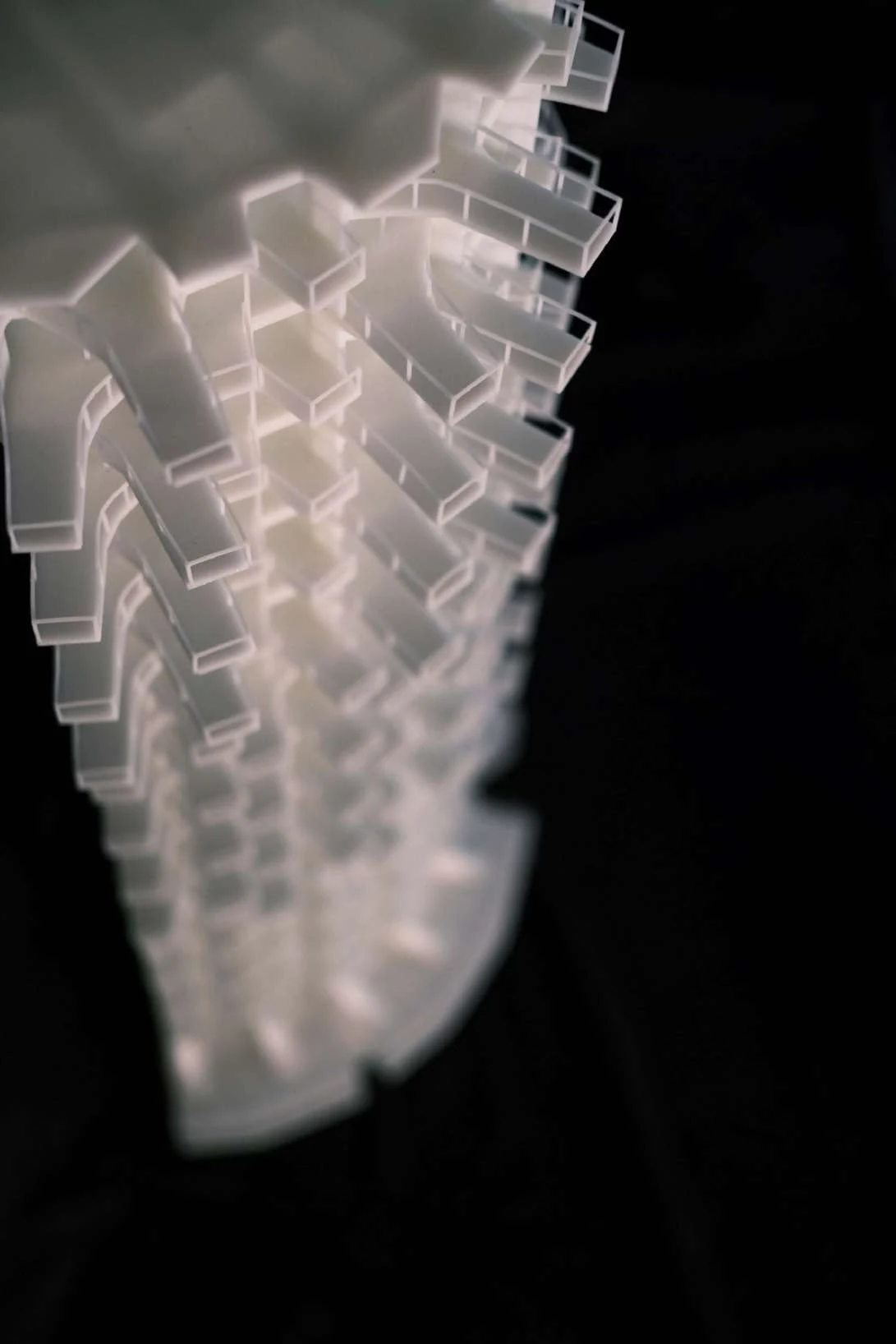 Translucent physical model of a high-rise tower with projecting outdoor spaces